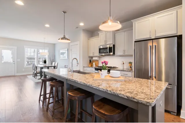 Bright, freshly cleaned kitchen with a polished granite island